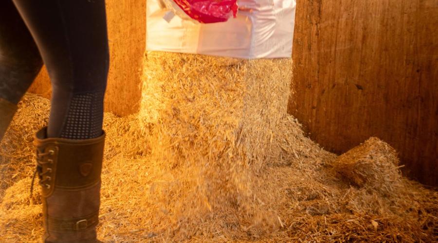 Someone emptying a bale of shavings