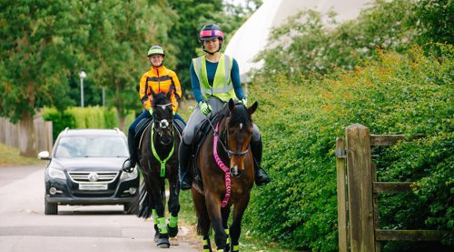 Horses And Riders In Hi Vis Hacking On The Road