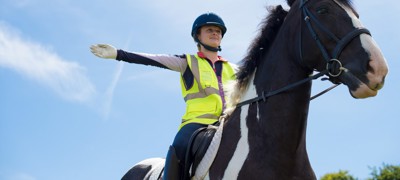 rider on a horse wearing hi vis 