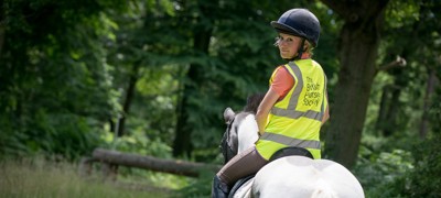 rider on horse wearing BHS hi vis