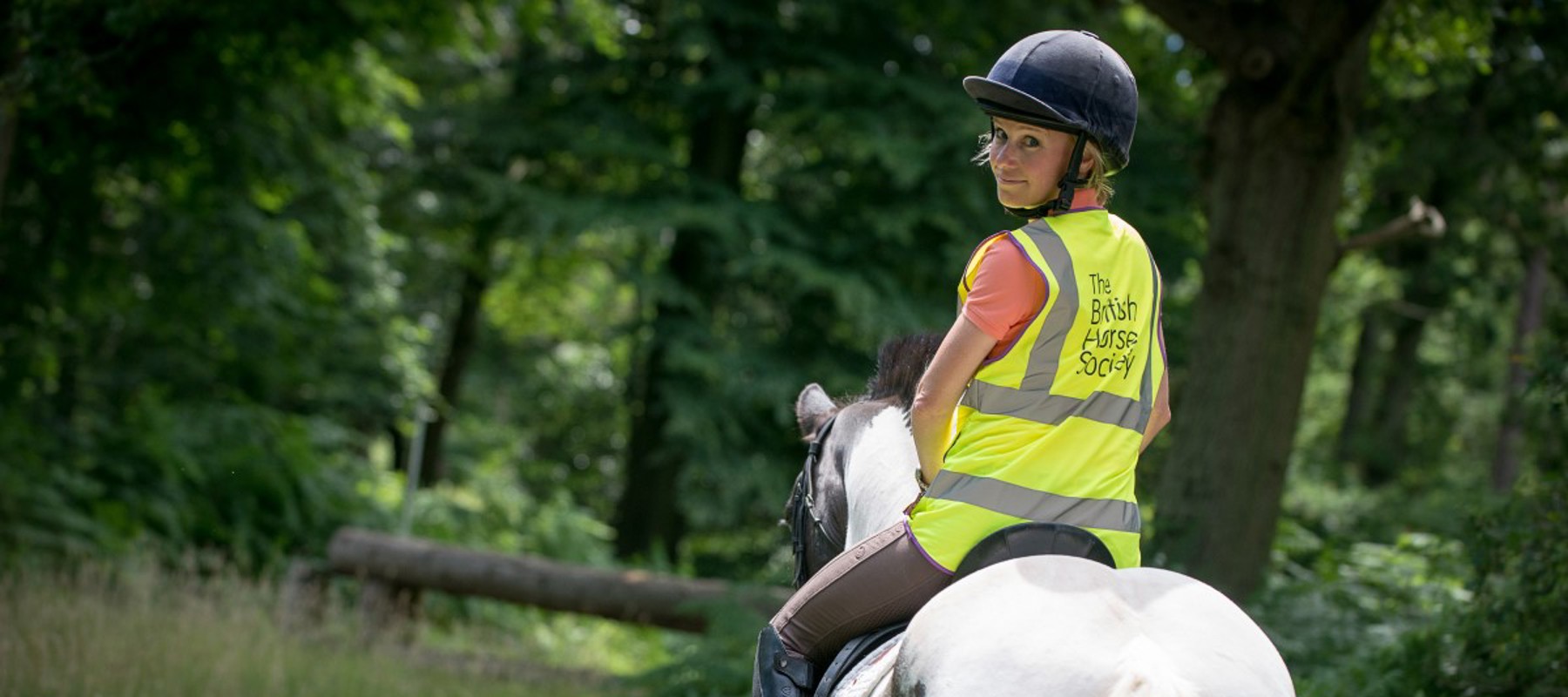 rider on horse wearing BHS hi vis