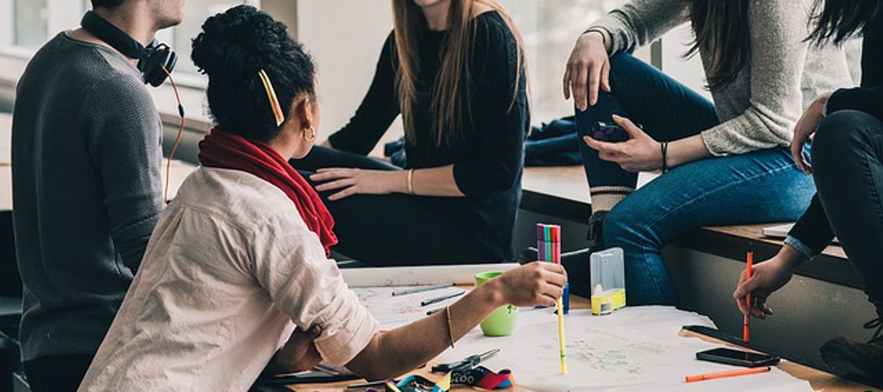 people discussing around a desk
