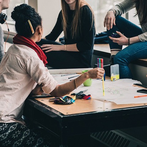 people discussing around a desk