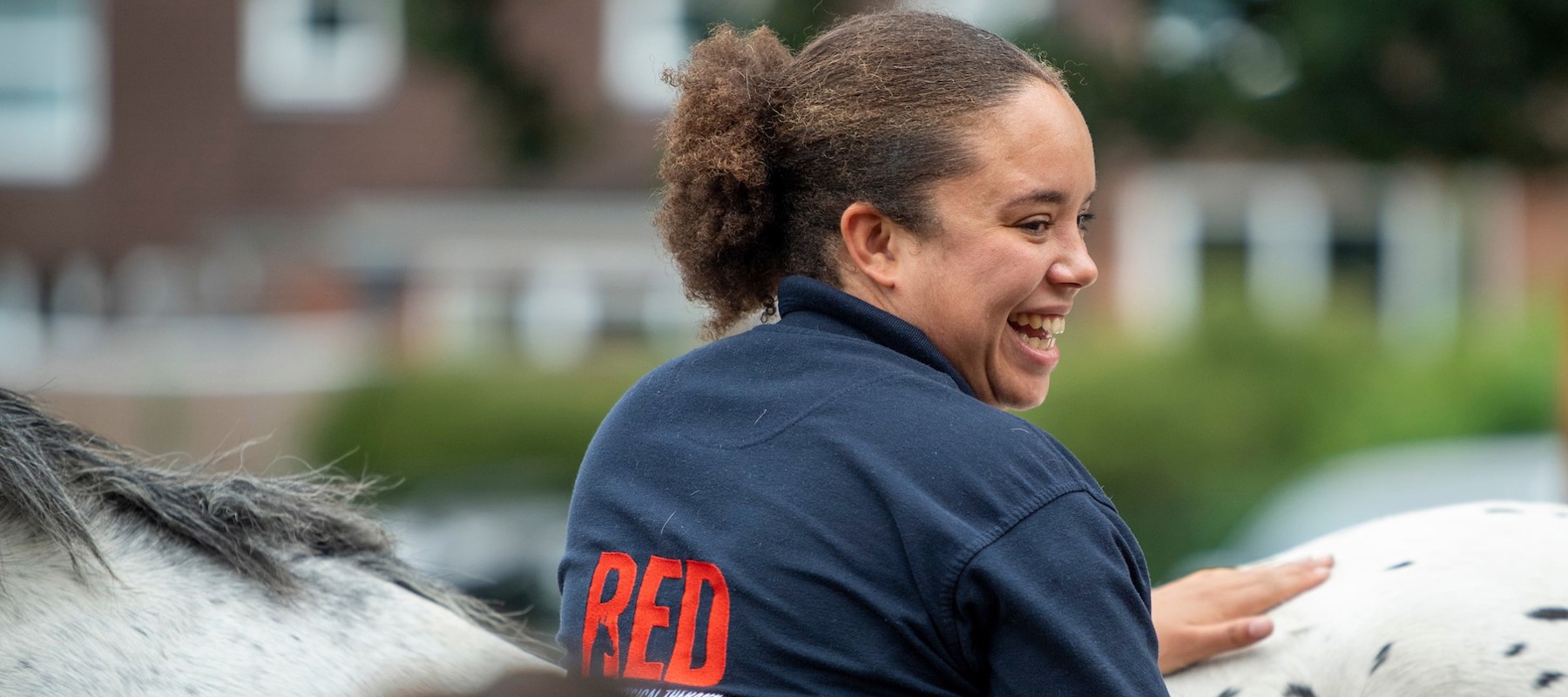 girl smiling near horse