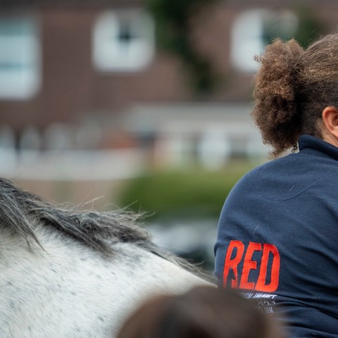 girl smiling near horse
