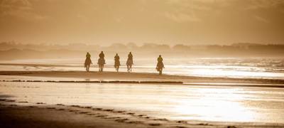 Riding on the beach at sunset
