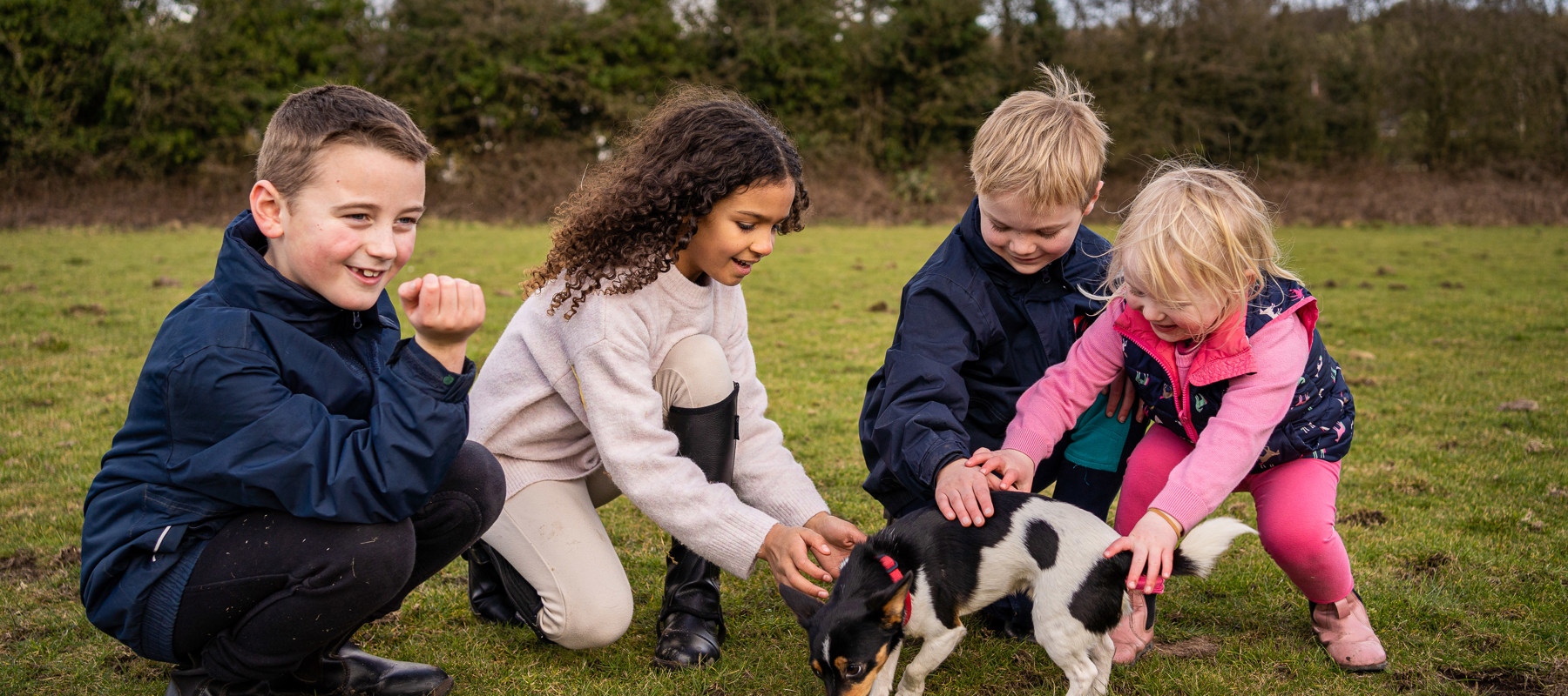 kids playing with a dog