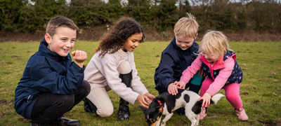 kids playing with a dog