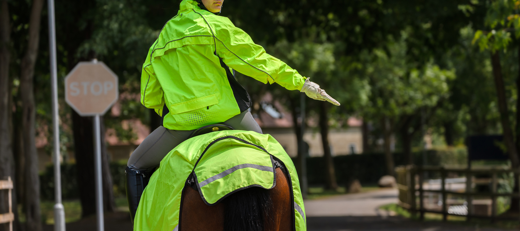 Rider In Hi Vis Signalling To Slow Down