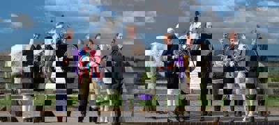 horse riders with horses showing rosettes