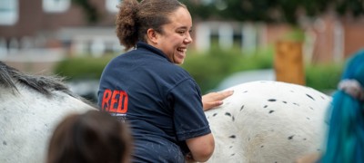 girl smiling near horse