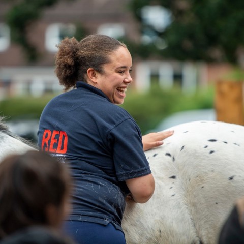 girl smiling near horse