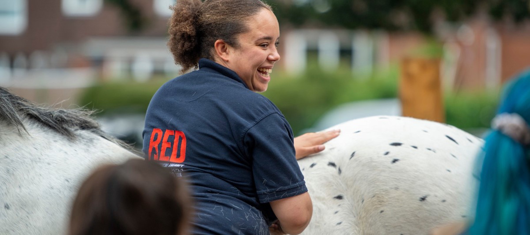 girl smiling near horse