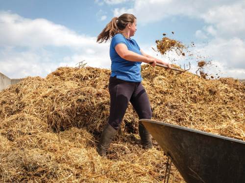 Lady pushing muck up the muckheap