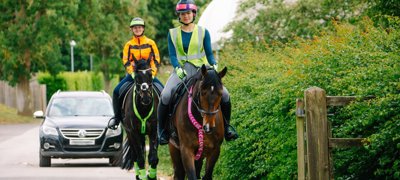 Horses And Riders In Hi Vis Hacking On The Road (1)