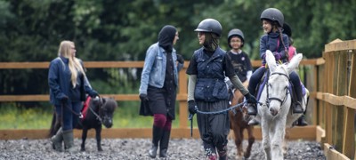 children riding on ponies
