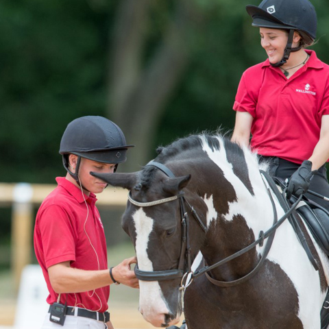 two young riders near a horse