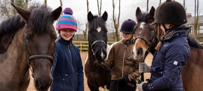 horse riders smiling near ponies parbold equestrian centre