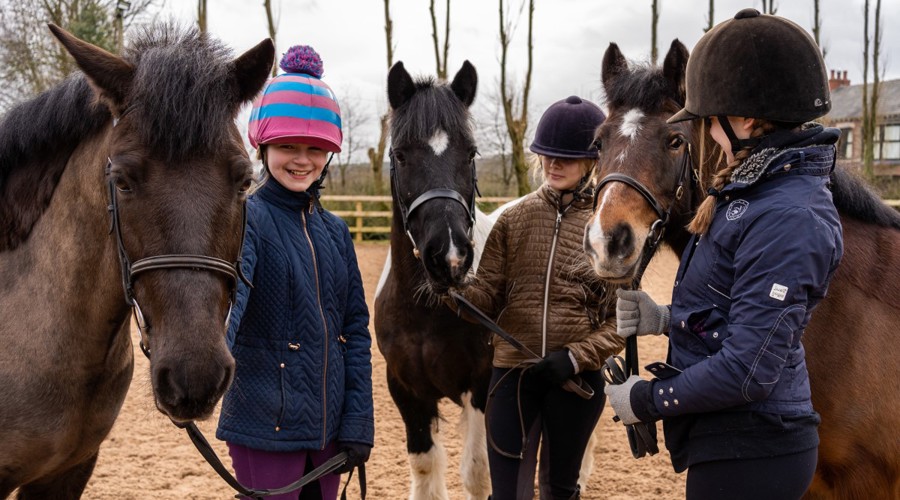 horse riders smiling near ponies parbold equestrian centre